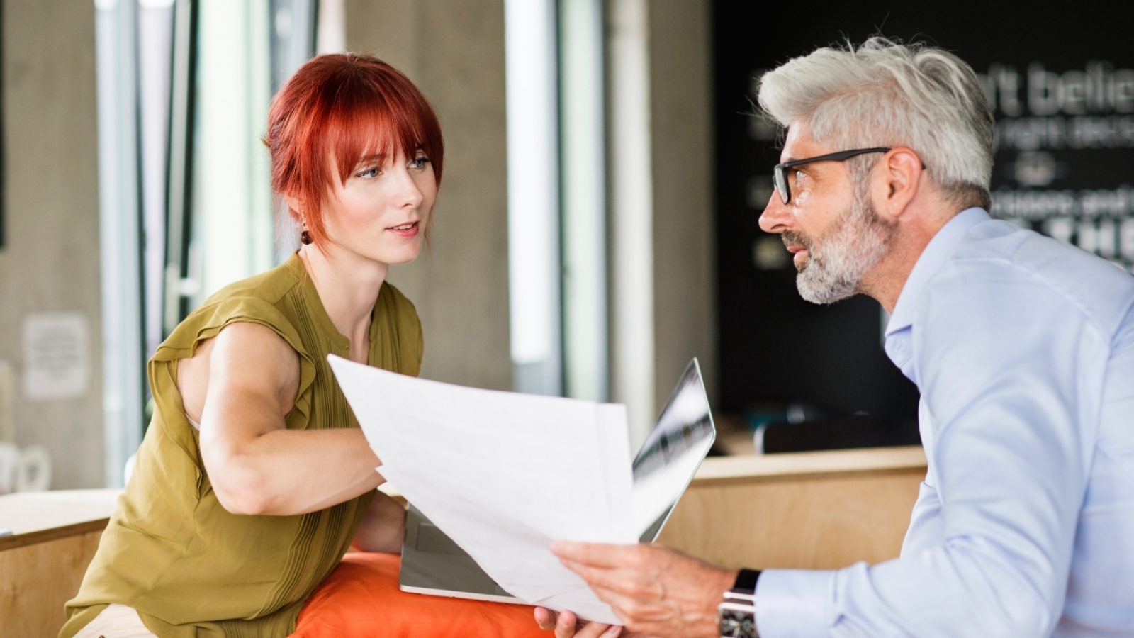 business-people-in-creative-office-consulting-a-P48WVT9-1600x900